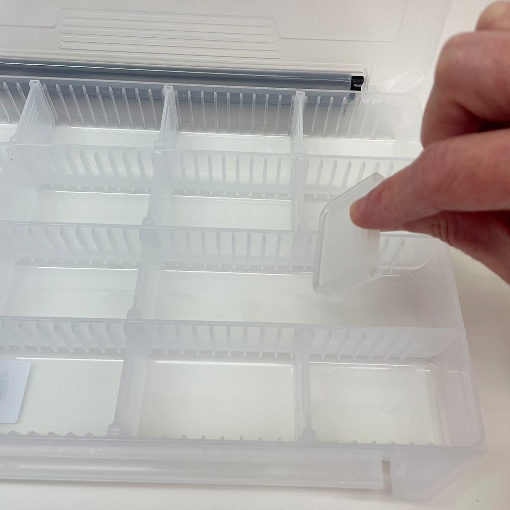 Adjustable compartment fly box 12363 shown with a person changing the dividers