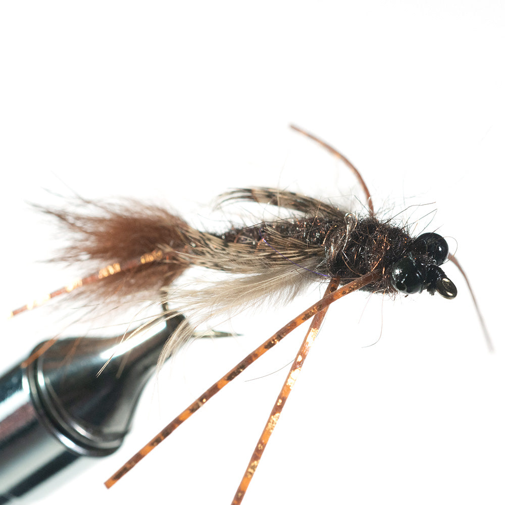Shown is a front view of  our Bass Caddis Nymph in a fly tying vise with a white background - Murray's Fly Shop Edinburg, VA 22824