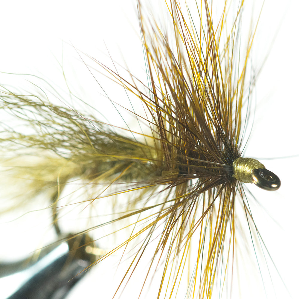 Murray's Olive Dragonfly Skater Dry Fly looking at the fly from the front on a white background being held in a fly tying vise