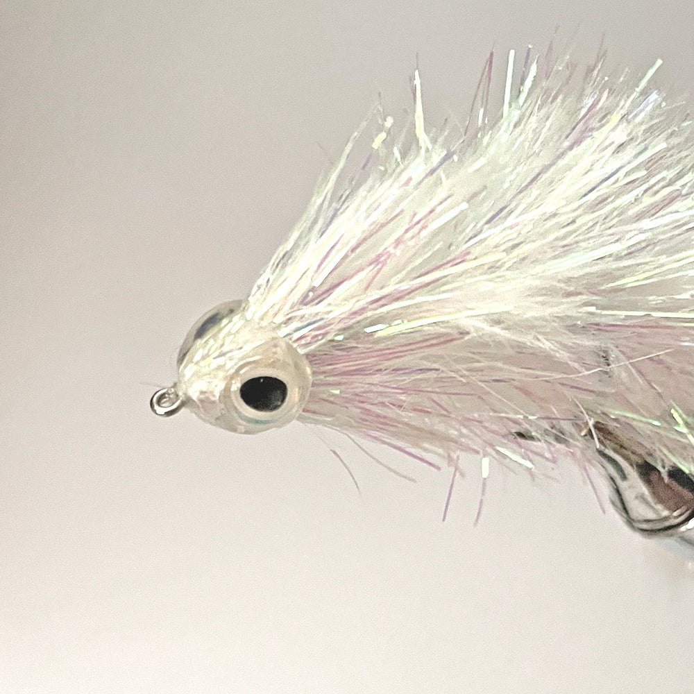 Fish Skull Fish Mask with eyes attached.  The Fish Mask is shown on a completed fly in a vise