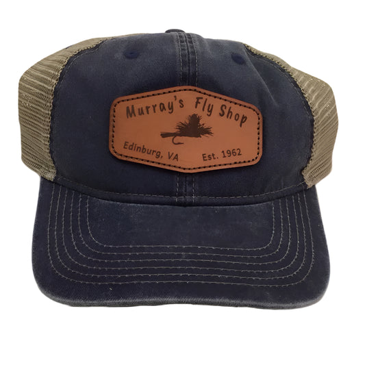 Murray's Fly Shop Leather patch logo sewn onto a blue soft crown hat with a tan mesh back