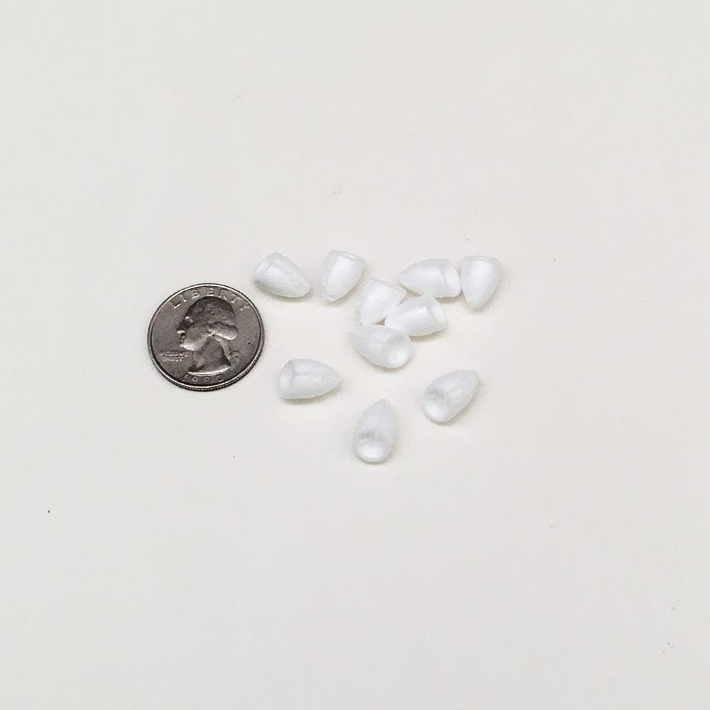 Popper bodies shown in comparison to a quarter. These bodies are used for building your own popping bugs fly tying.