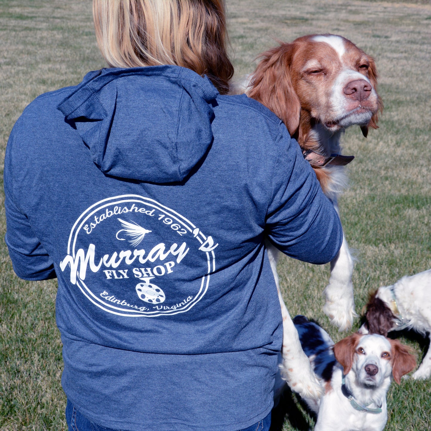 Frost Blue - Pictured is a girl wearing a Frost Blue Murray's Fly Shop Hooded long sleeve sun shirt. Also pictured are three Brittany Spaniel dogs.