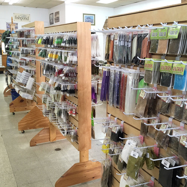 Display racks with fly tying material hanging on them inside Murray's Fly Sho in Edinburg, VA