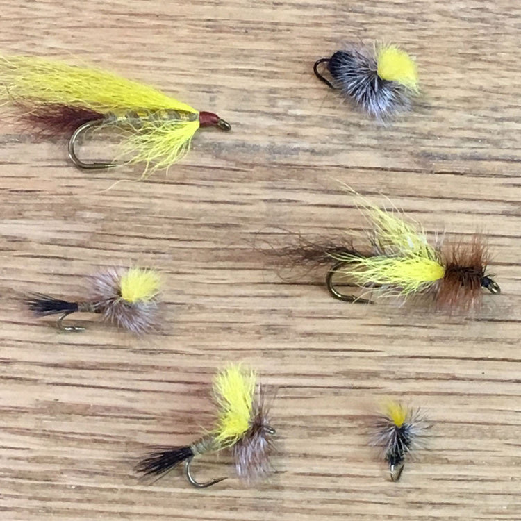 Mr. Rapidan fly patterns - streamer, ant, parachute, midge, skater and traditional dry fly shown on a white oak board