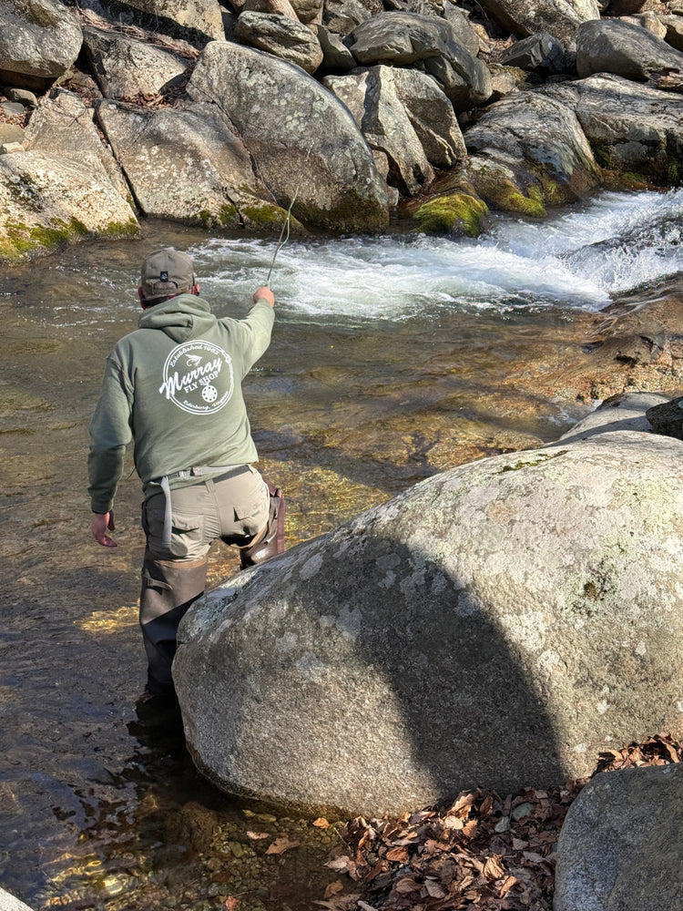Spring trout fly fishing essentials including trout flies, leaders, and gear from Murray's Fly Shop are being used by this angler on a Rocky Mountain stream in the Blue Ridge Mountains of Virginia