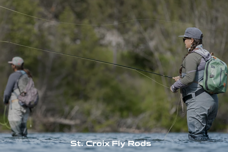 Two anglers fly fishing in a river with fly line arcing through the air — St. Croix Fly Rods at Murray's Fly Shop