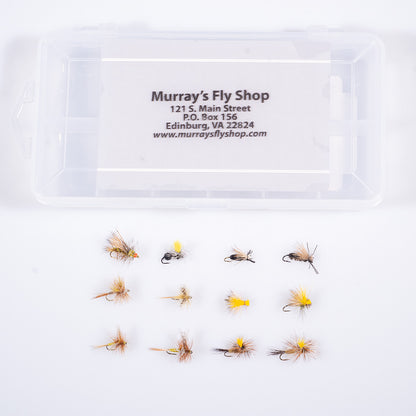 A 12-compartment plastic fly box containing a curated assortment of Murray's trout dry flies, showing the Murray's Fly Shop logo on the clear lid.