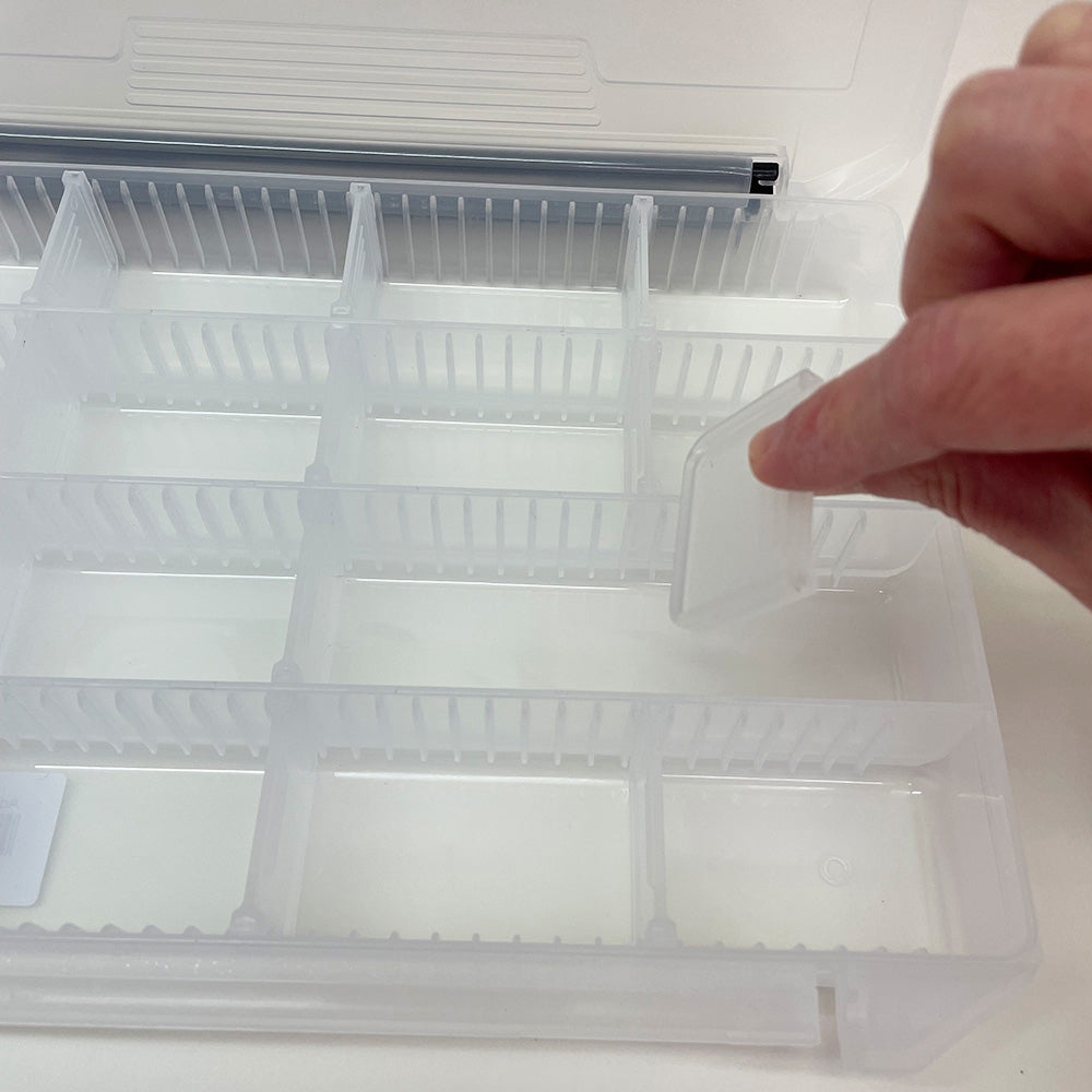 Adjustable compartment fly box 12363 shown with a person changing the dividers 