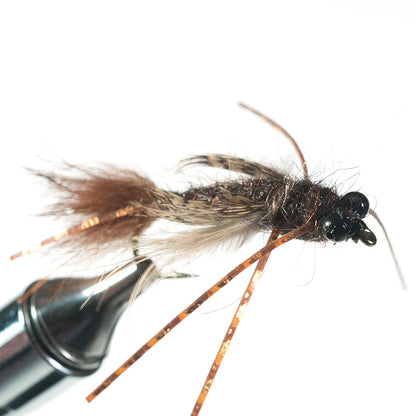 Shown is a front view of  our Bass Caddis Nymph in a fly tying vise with a white background - Murray's Fly Shop Edinburg, VA 22824
