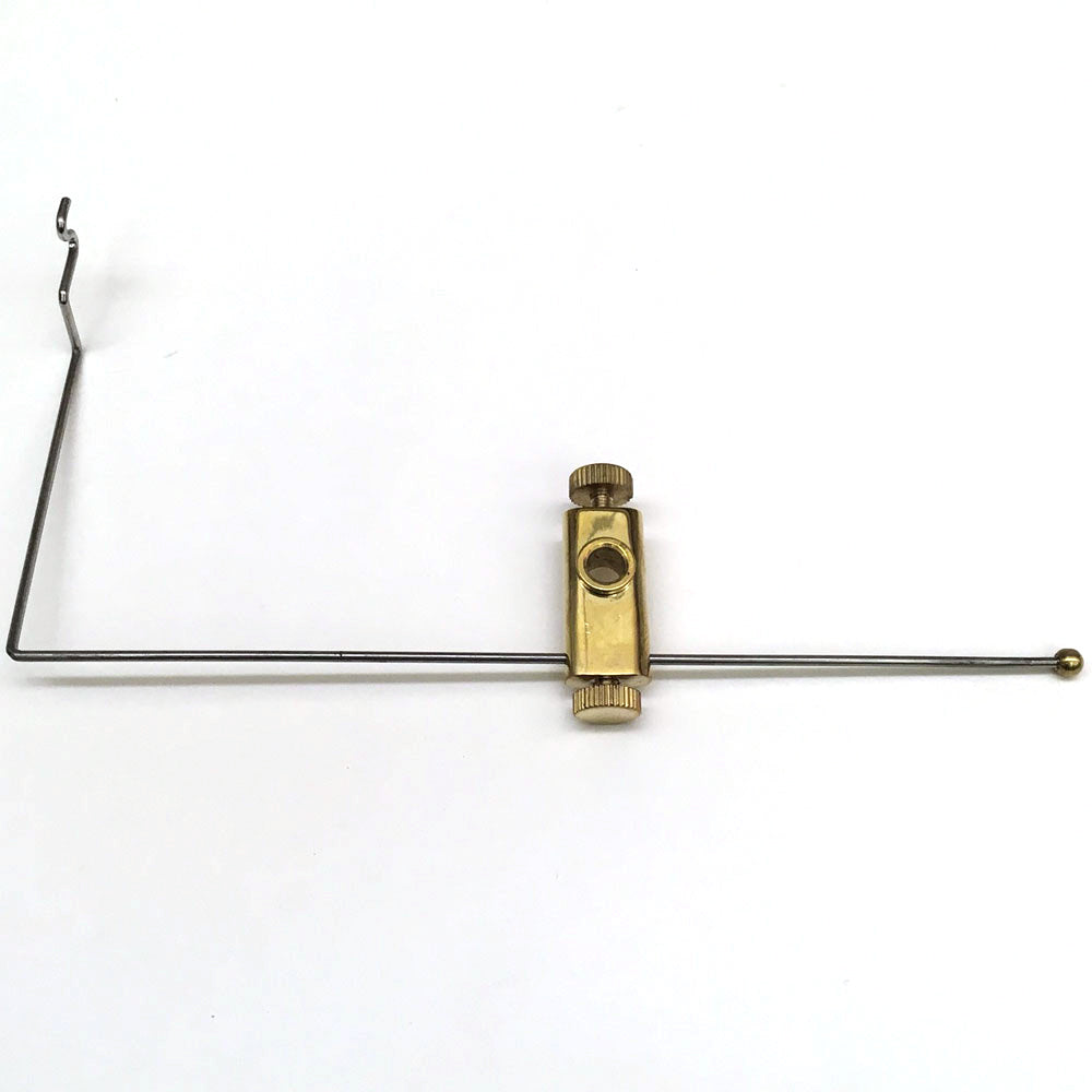 A bobbin cradle used with a fly tying vise to hold the bobbin and thread out of the way