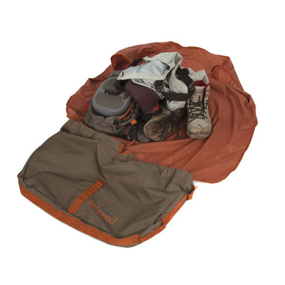 Fishpond Burrito Wader Bag shown opened up with wading boots, waders and a fishing pack inside