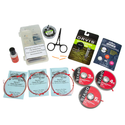 Flat layout of the Murray's Loaded Fly Fishing Accessory Kit featuring a closed opaque fly box with 22 flies, assorted leaders, tippet spools, Orvis nipper and zinger, Dr. Slick forceps, scientific anglers dry fly floatant, split shot, and Oros strike indicators.