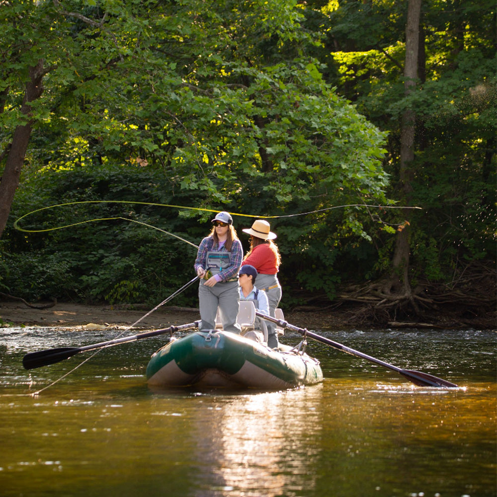 Two anglers on a boat fly fishing with an Orvis Freshwater Fly Fishing Rod