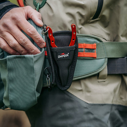 Umpqua Trout Pliers with sheath and lanyard for easy pack or belt carry shown on a fishing pack being worn by an angler