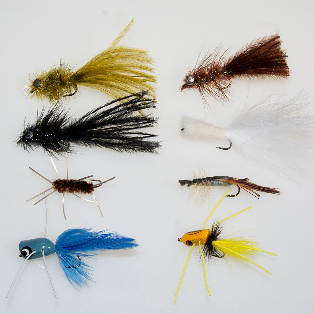 An assortment of bass streamers, nymphs, crayfish and popper patterns to fish on low water bass rivers at the end of summer