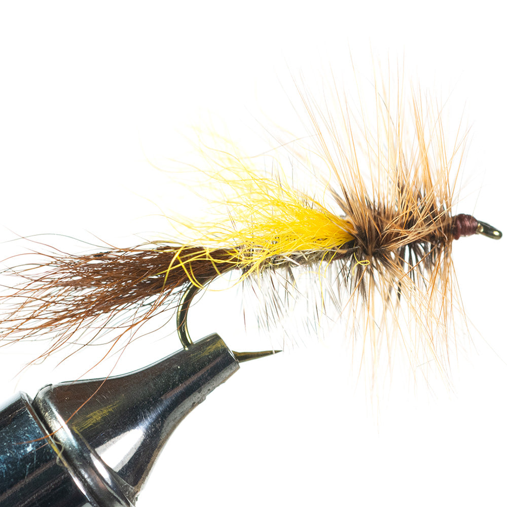 Mr. Rapidan Skater looking at the fly from the side in a fly tying vise with a white background