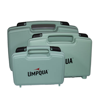 Three sage green Umpqua Boat Boxes in Baby, Ultimate, and Magnum sizes stacked by size on a solid white background, showcasing the durable fly fishing tackle boxes