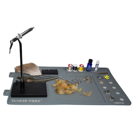Fly tying vise and materials on display on the Yankee Fork magnetic fly tying mat to help you keep your fly tying supplies organized.