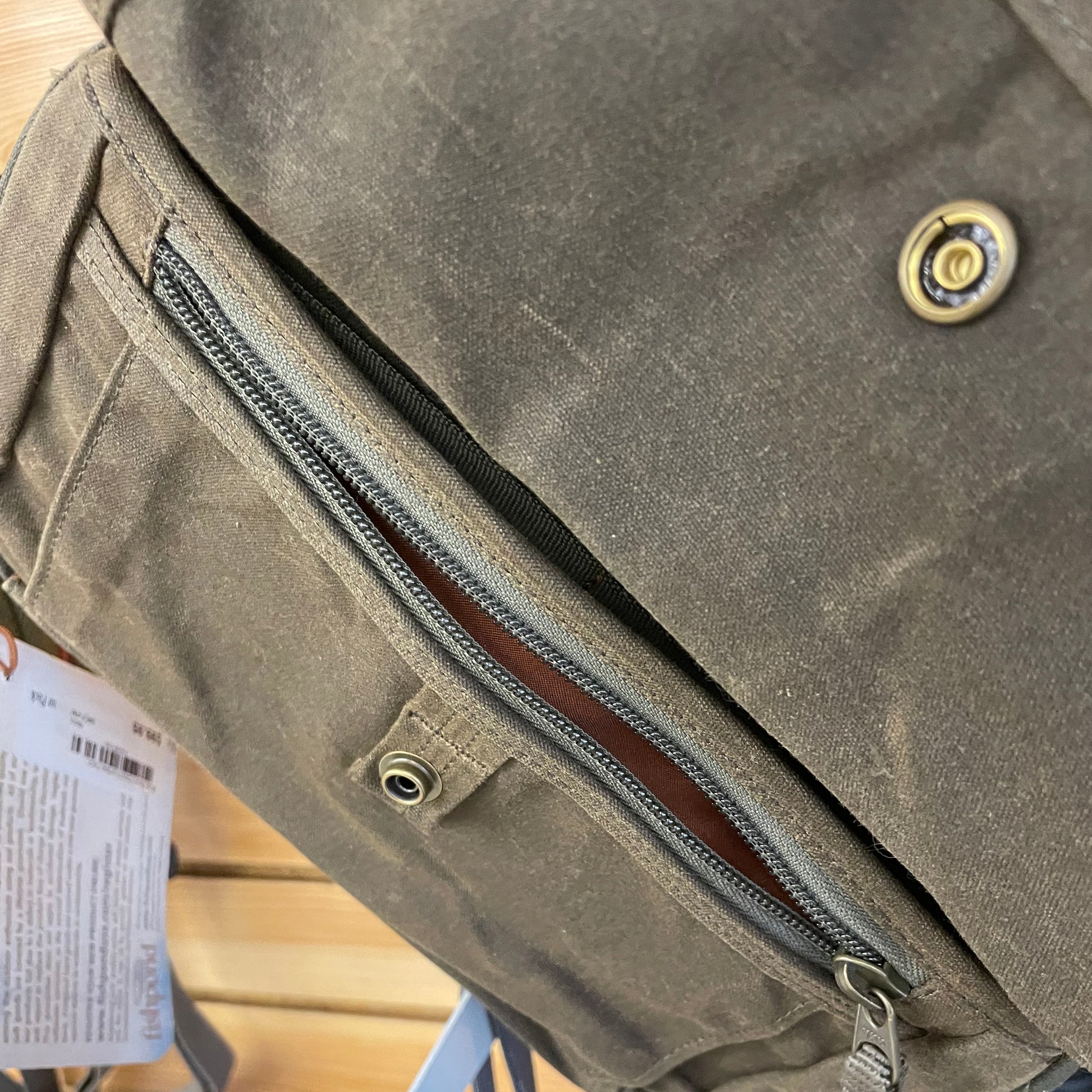 Fishpond Blue River Chest/ Lumbar Pack front compartment show with a small zippered pocket and a button over flap