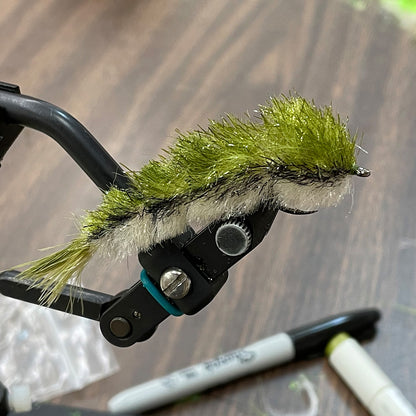 Fly tying class participants produce an Articulated Minnow Changer like this with instructor Brandon.
