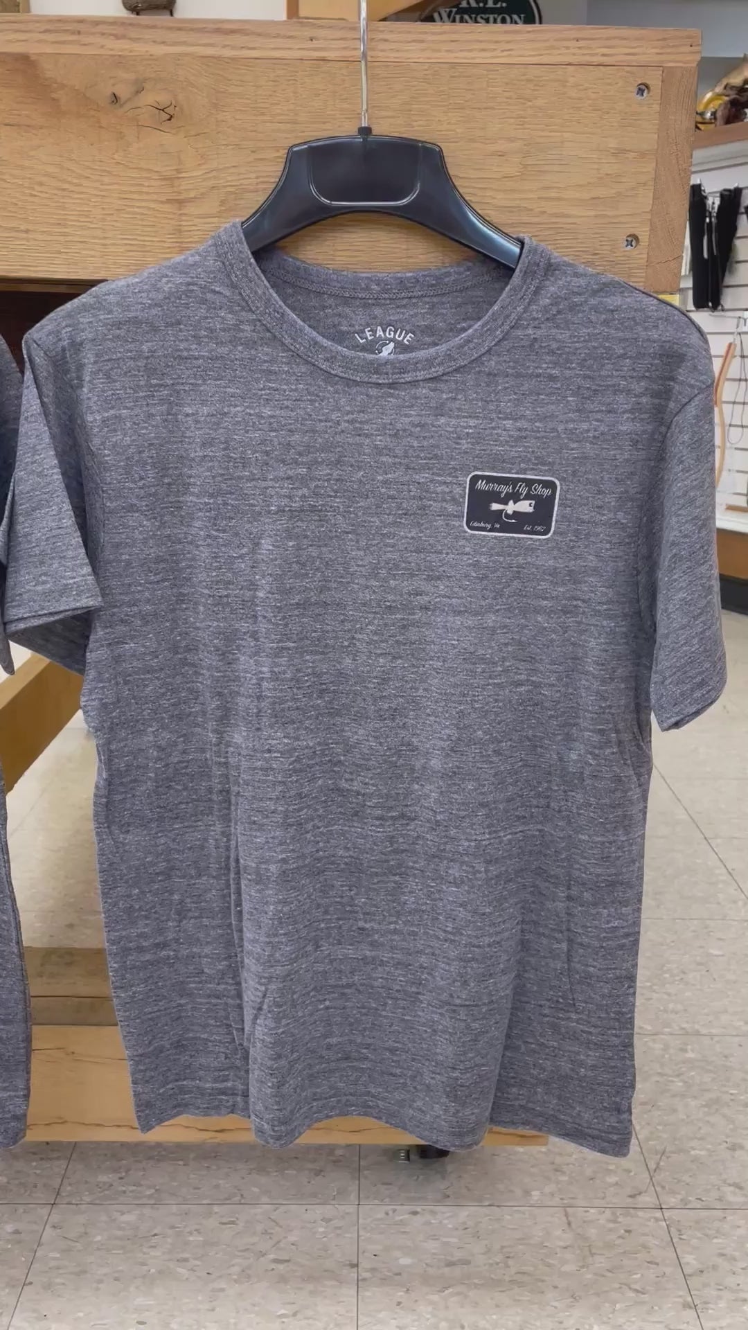 video of Murray's Bass Graphic T-Shirts displaying a bass and fly rod on the back. Available in two colors.