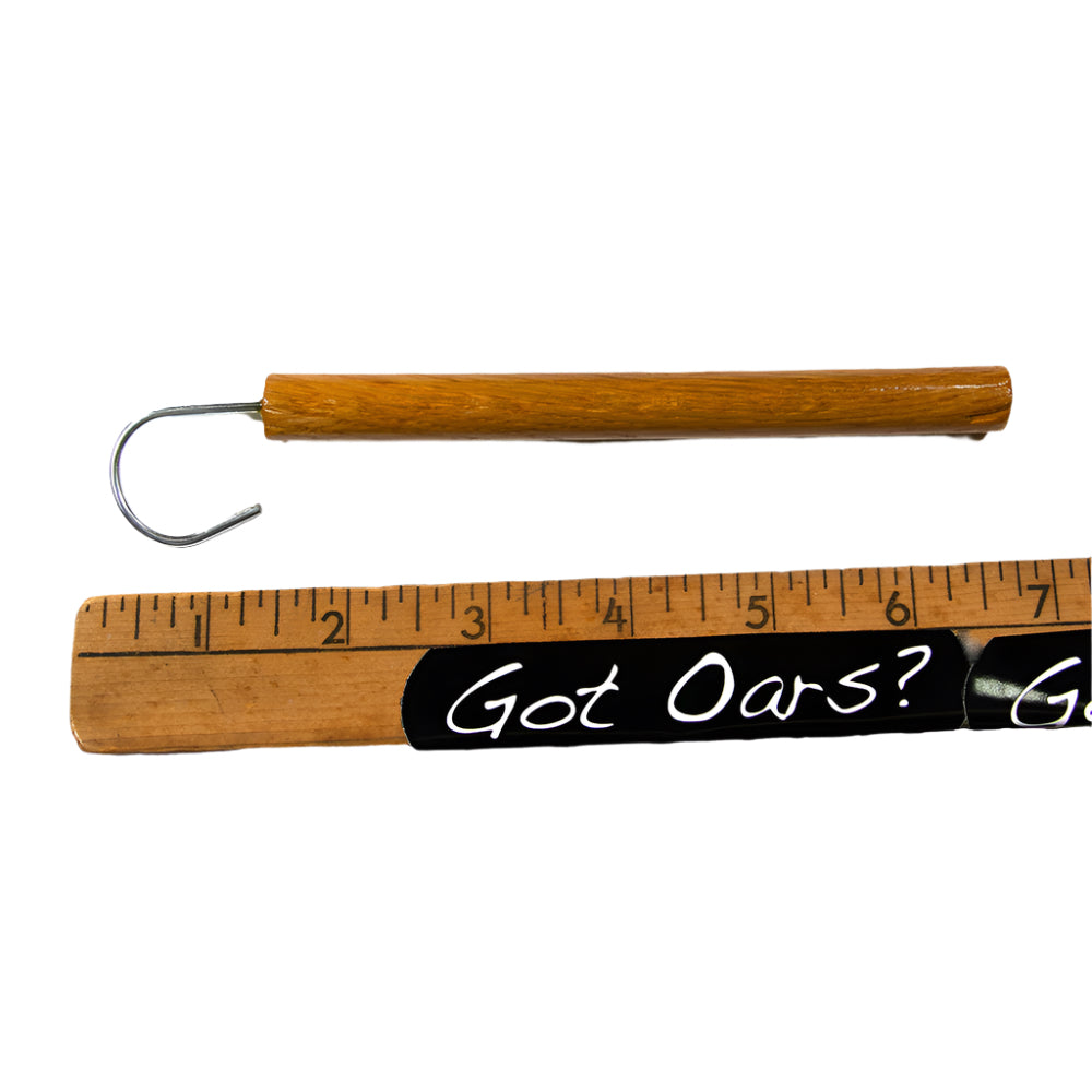 Fish Hook Release tool with oak handle shown with a ruler for referencing approximate size.  This is shown on a white background.