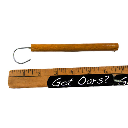 Fish Hook Release tool with oak handle shown with a ruler for referencing approximate size.  This is shown on a white background.