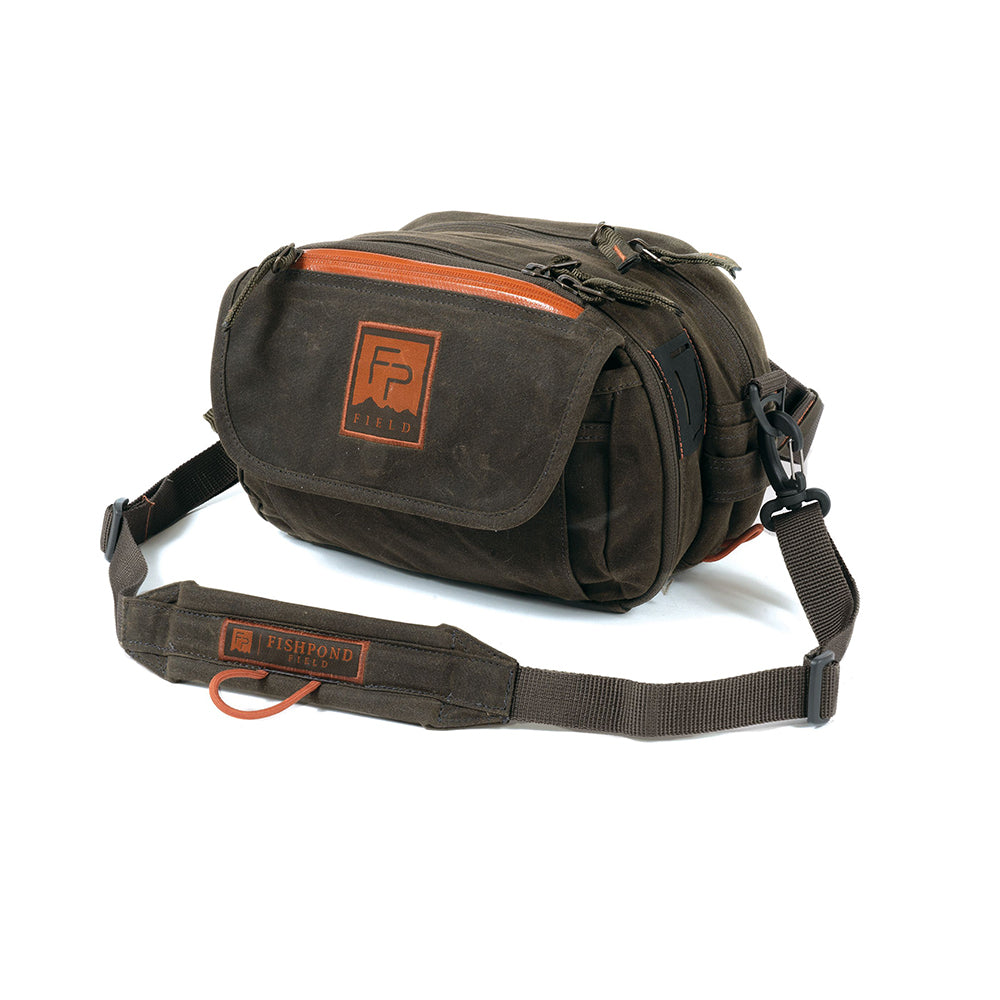 Blue River Lumbar Fishing Pack made from waxed cotton canvas is shown on a white background