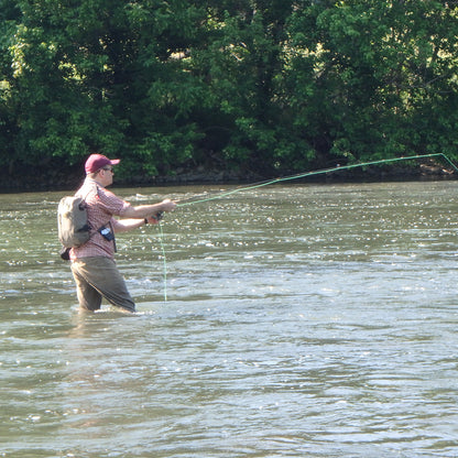 Half Day Fly Fishing Lessons - Showing an angler holding a fly rod standing in the Shenandoah River of Virginia learning to fly fish for smallmouth bass