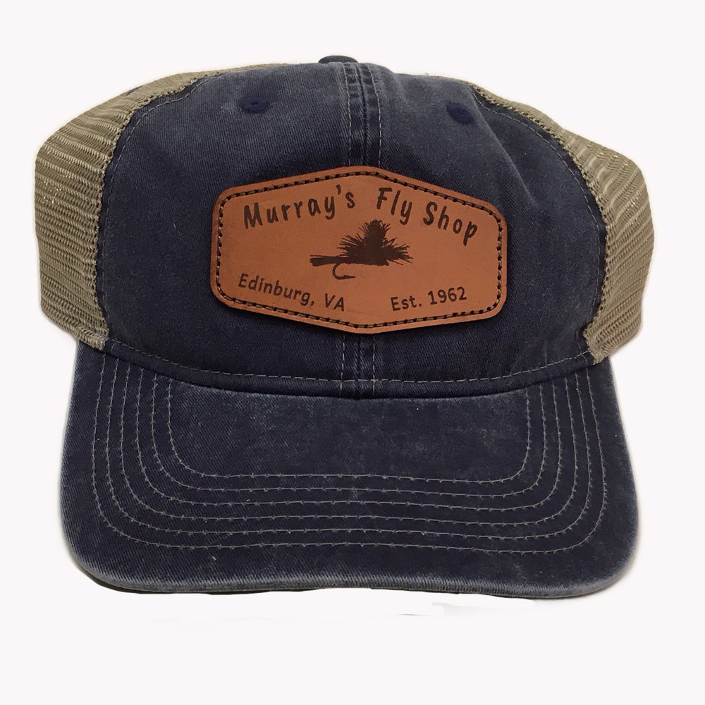 Murray's Fly Shop Leather patch logo sewn onto a blue soft crown hat with a tan mesh back