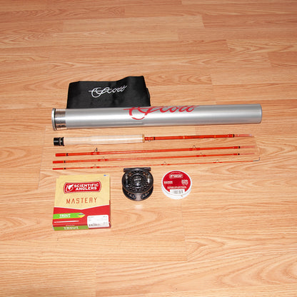 Scott F Series 622/4 fiberglass fly rod showing the handcrafted fly rod in four pieces, cork grip, Scientific Anglers Fly Line, Orvis Battenkill Disk Fly Reel, Fly Line Backing and high quality aluminum fly rod tube