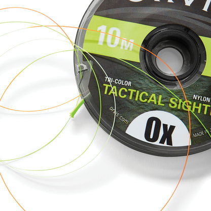 A close-up of a spool of Orvis Tactical Sighter Tippet with visible multicolor lines indicating the tippet material, labeled for 0X strength.