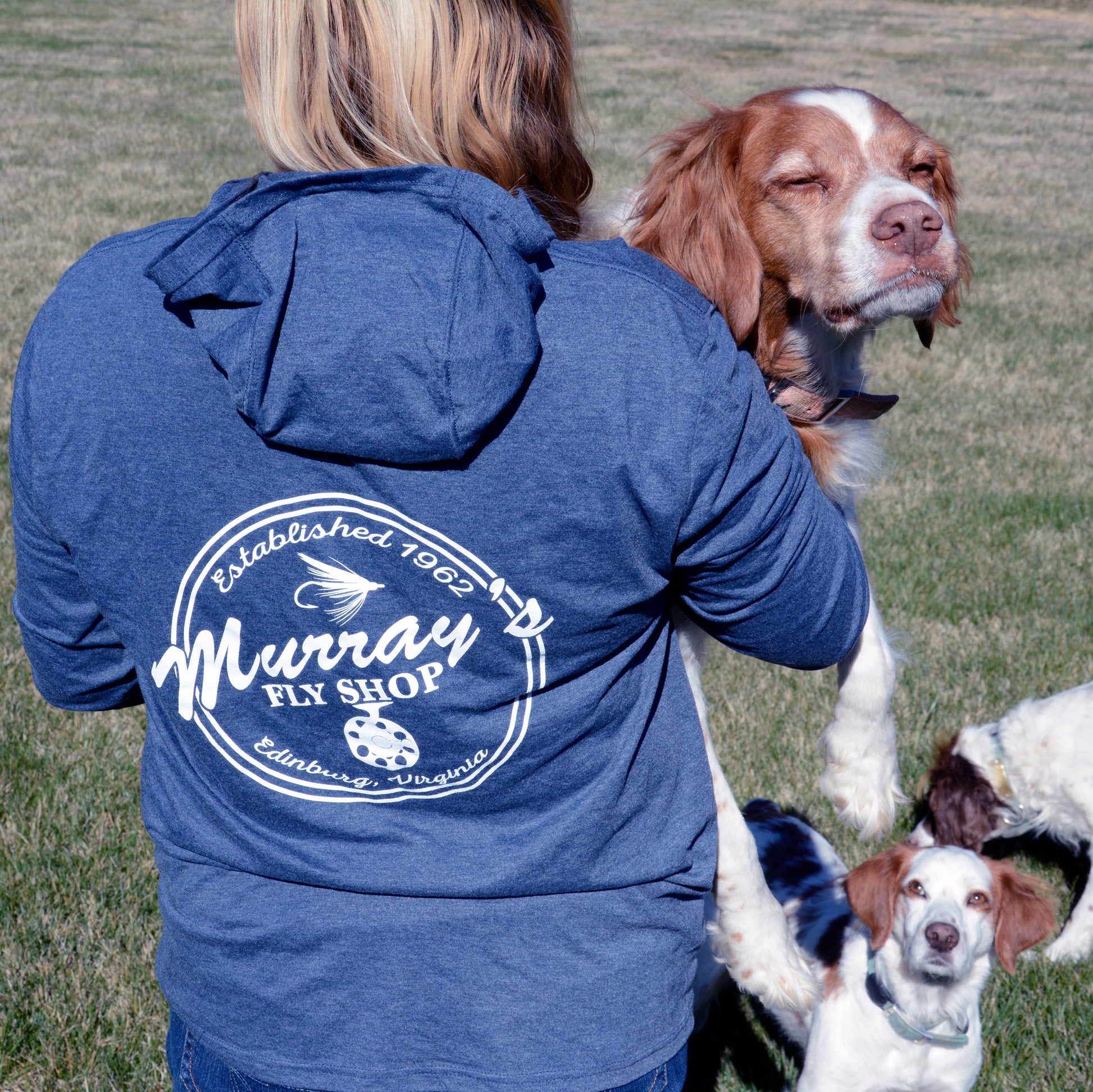 Frost Blue - Pictured is a girl wearing a Frost Blue Murray's Fly Shop Hooded long sleeve sun shirt.  Also pictured are three Brittany Spaniel dogs.
